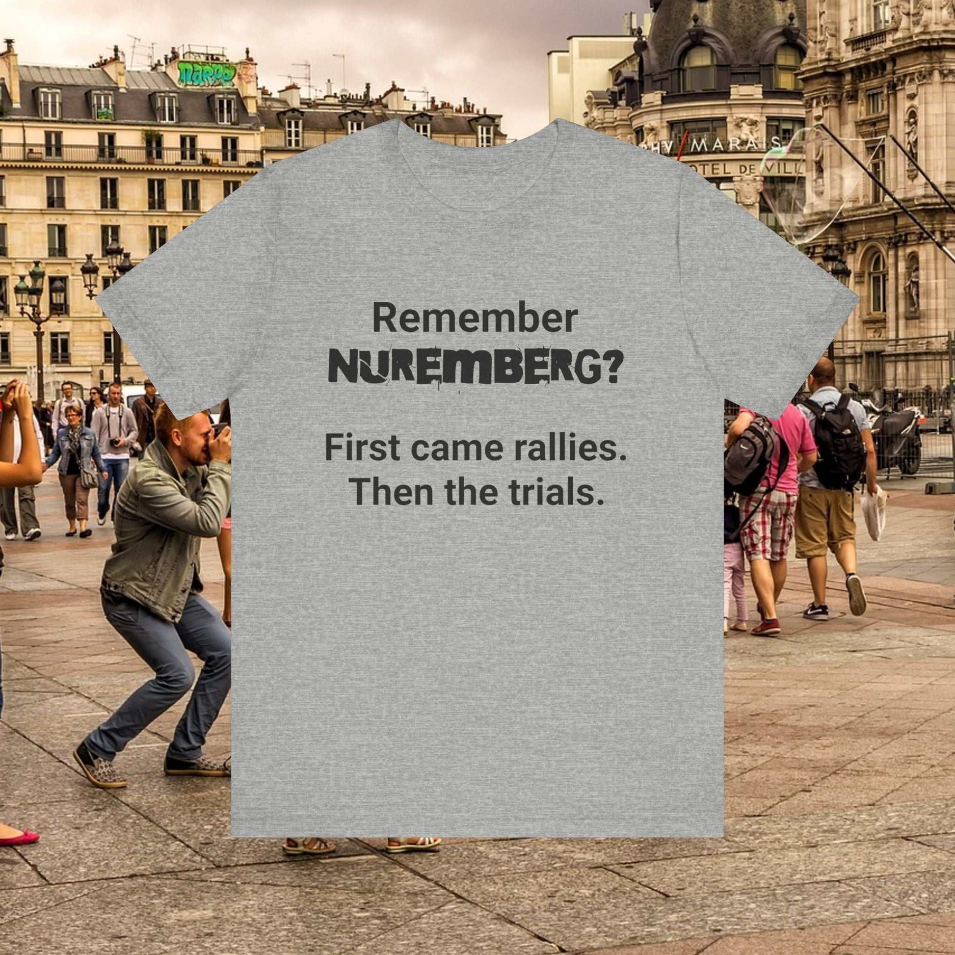 Nuremberg light grey t-shirt with text 'Remember Nuremberg? First came rallies. Then the trials.'