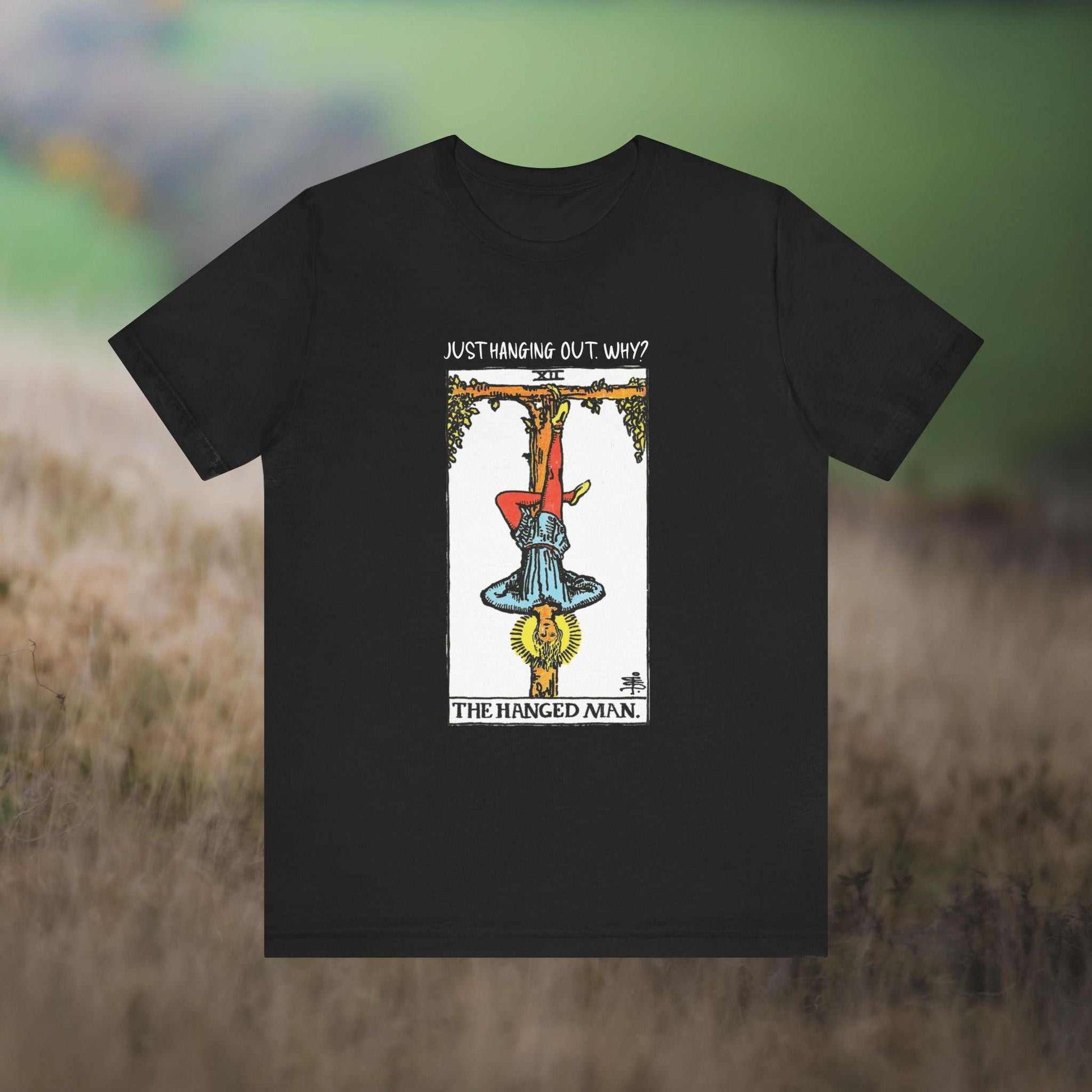 Hanged Man Tarot w text "Just Hanging Out, Why?' on a black tee