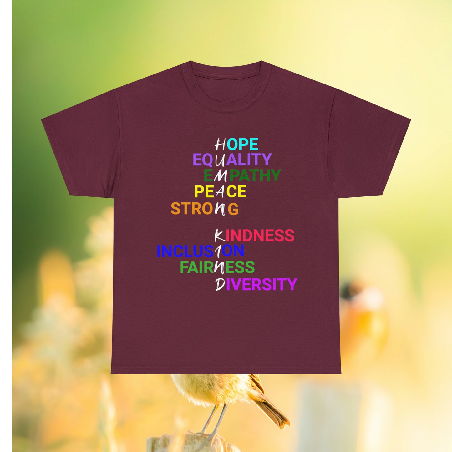 Maroon tee with graphic "Human Kind" on a field background