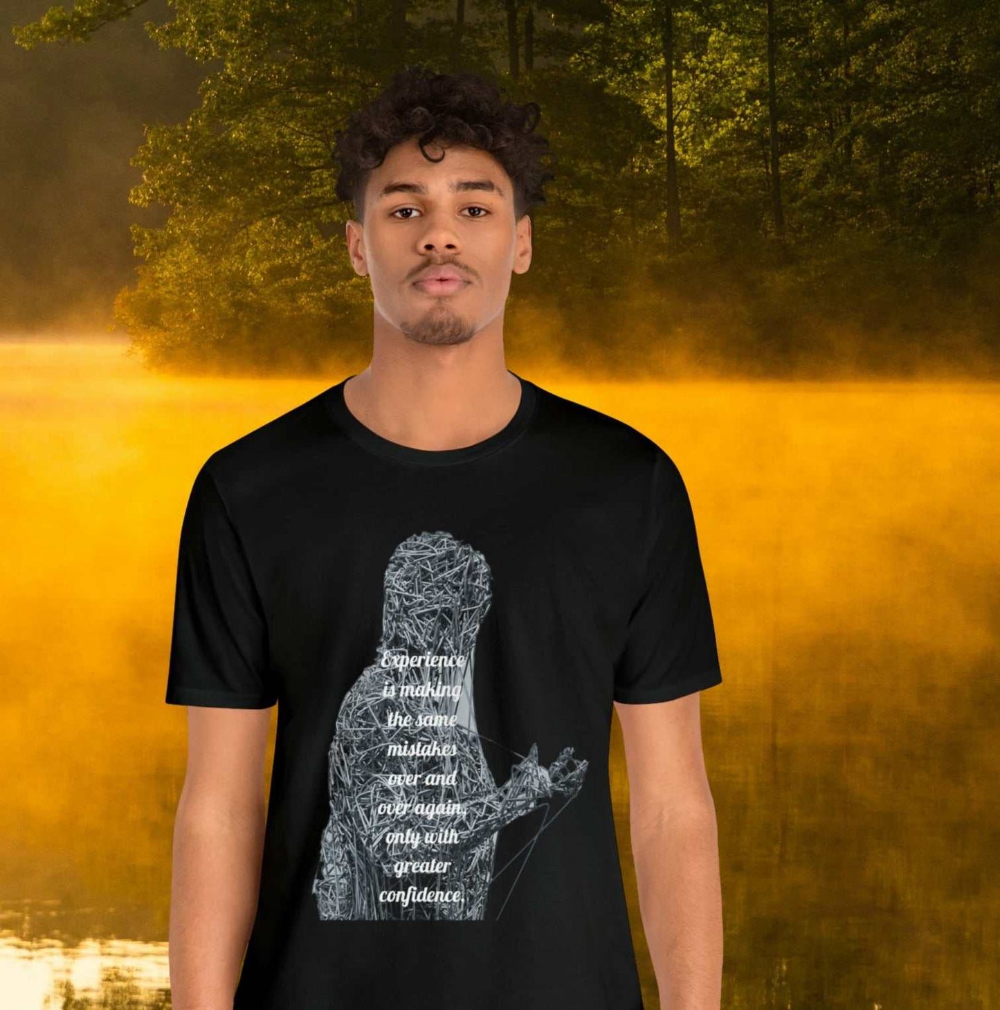 Young man wearing black tee on golden pond background with "Experience is making the same mistakes" monster graphic.