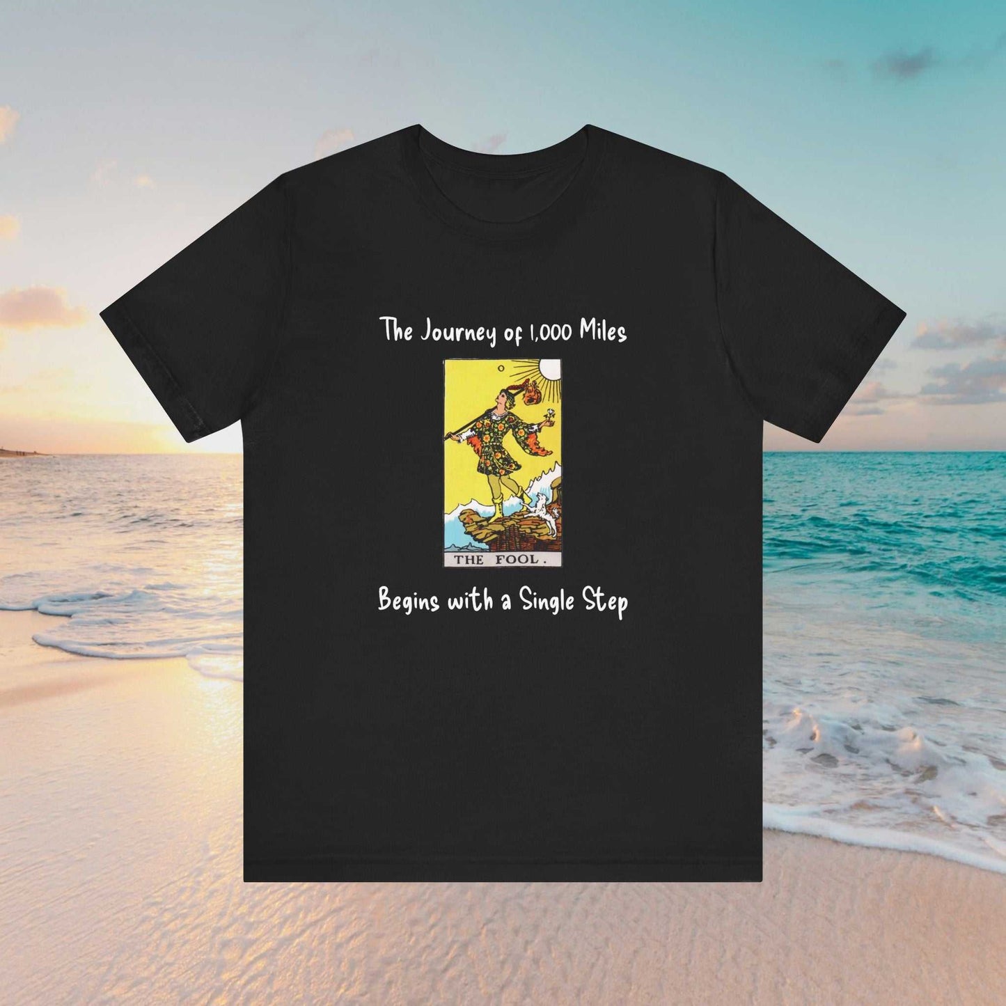 The Fool tarot graphic and text of 'The Journey of 1,000 Miles Begins with a Single Step" on a black tee
