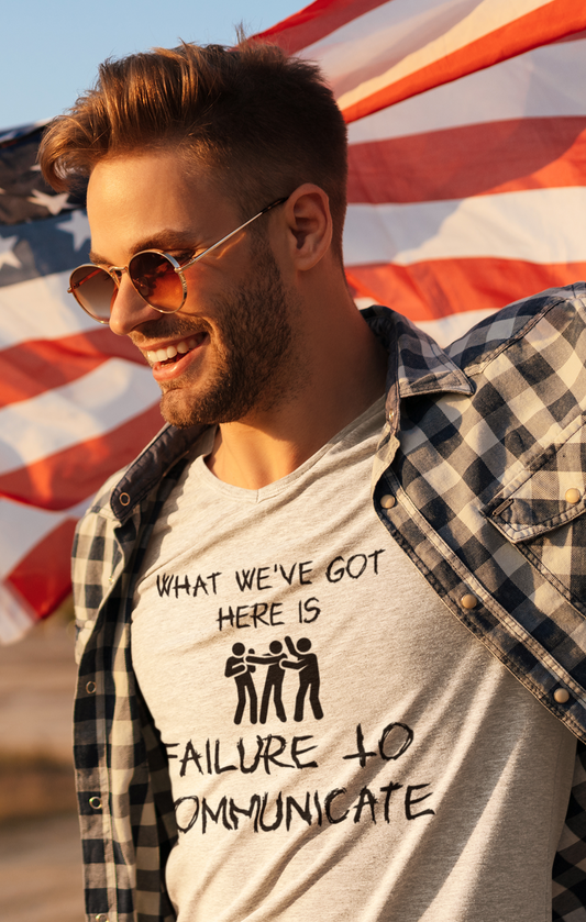 Stylish man with flag backdrop wearing tan shirt with graphic