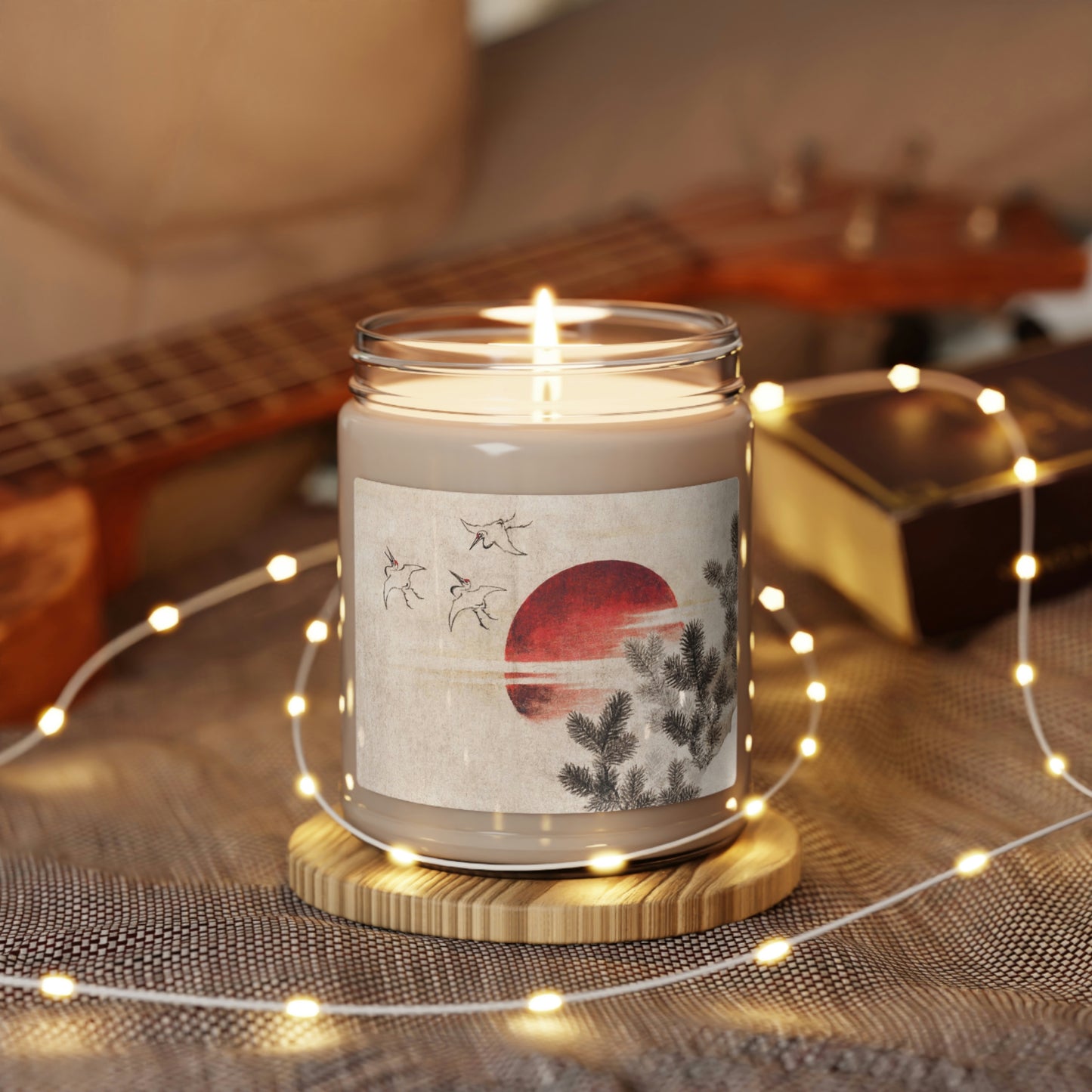 "Clean Cotton" Scented Soy Candle jar with Hokusai print 'birds and sunset' on table with white LED chain