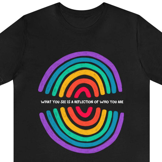 Reflection. What you see is a reflection of who you are - text between a reverse color reflection rainbow, on a black tee.
