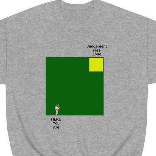 Judgement Free Zone text above small yellow square inside a large green block, text HERE You Are on opposite corner from yellow square, on a grey shirt